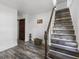 Wooden staircase with a dark wood banister and new flooring, adding a touch of warmth to the house at 997 Yandes St, Franklin, IN 46131