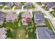 A bird's-eye view showcasing a home's backyard with a patio and lush landscaping in a suburban setting at 1013 Domino Dr, Carmel, IN 46032
