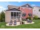Beautiful backyard with a screened-in porch, patio seating, and lush green grass at 1013 Domino Dr, Carmel, IN 46032