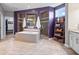 Modern bathroom featuring a soaking tub, glass-enclosed shower, and neutral-toned tile at 1013 Domino Dr, Carmel, IN 46032