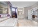 Bright bathroom boasts a soaking tub, walk-in shower, and natural-tone tile at 1013 Domino Dr, Carmel, IN 46032