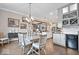 Dining room with an open view to the kitchen and living area, adjacent to a wet bar at 1013 Domino Dr, Carmel, IN 46032