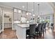 Bright kitchen featuring a center island with bar seating and modern light fixtures at 1013 Domino Dr, Carmel, IN 46032
