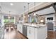 Open kitchen with a large granite island overlooking the dining area and living space at 1013 Domino Dr, Carmel, IN 46032