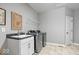 Well-lit laundry room features stainless steel washer and dryer with a sink, cabinet and overhead shelving at 1013 Domino Dr, Carmel, IN 46032