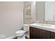 Powder room featuring a vanity with solid surface countertop and traditional fixtures at 1013 Domino Dr, Carmel, IN 46032