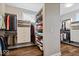 Well-organized walk-in closet with custom shelving, hanging racks, and wood-look flooring at 1013 Domino Dr, Carmel, IN 46032