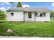 Charming single-story home with white siding, a covered porch, and a well-maintained green lawn at 1020 E Sixth St, Greenfield, IN 46140
