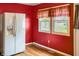 Bright kitchen featuring red walls, a white refrigerator, and a window view at 1020 E Sixth St, Greenfield, IN 46140