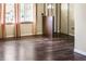 Spacious living room boasting hardwood floors, natural light, and entryways to other rooms at 1020 E Sixth St, Greenfield, IN 46140
