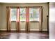 Bright living room featuring hardwood floors, large windows with curtains, and ample natural light at 1020 E Sixth St, Greenfield, IN 46140