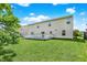 Expansive backyard with a manicured lawn, wooden deck, and mature trees providing shade and character at 10828 Young Lake Dr, Indianapolis, IN 46229