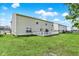 Spacious backyard with a well-maintained lawn, wooden deck, and partial fence for privacy at 10828 Young Lake Dr, Indianapolis, IN 46229
