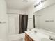 Bright bathroom featuring a shower-tub combo and double sink vanity with a large mirror at 10828 Young Lake Dr, Indianapolis, IN 46229