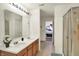 Bathroom featuring a double vanity, shower, and access to other rooms, blending convenience and comfort at 10828 Young Lake Dr, Indianapolis, IN 46229