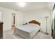 Well-lit bedroom featuring a window, bed, and decor, and carpeted floors at 10828 Young Lake Dr, Indianapolis, IN 46229