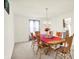 Light-filled dining room with chandelier and traditional wooden table and chairs at 10828 Young Lake Dr, Indianapolis, IN 46229