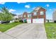 Beautiful two-story home with a spacious driveway, lush green lawn, and charming blue accents at 10828 Young Lake Dr, Indianapolis, IN 46229