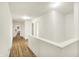 Bright hallway with light-colored walls and hardwood flooring at 10828 Young Lake Dr, Indianapolis, IN 46229