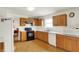 Spacious kitchen with wood cabinets, white countertops, and modern appliances at 10828 Young Lake Dr, Indianapolis, IN 46229