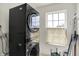 Laundry area with stacked washer and dryer and a window at 10828 Young Lake Dr, Indianapolis, IN 46229