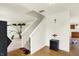 Bright living room with a view of the stairs, hardwood floors, and a plant at 10828 Young Lake Dr, Indianapolis, IN 46229