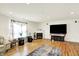 Bright and open living room features wood floors and a cozy fireplace at 10828 Young Lake Dr, Indianapolis, IN 46229