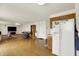 Open concept living area adjacent to the kitchen with laminate flooring and fireplace feature at 10828 Young Lake Dr, Indianapolis, IN 46229