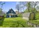 An inviting backyard showcases a blue house, a shed, and a well-manicured lawn at 1130 W Congress Ave, Indianapolis, IN 46208