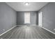 Neutral bedroom with hardwood-style flooring and a bright window, perfect for relaxation at 1130 W Congress Ave, Indianapolis, IN 46208