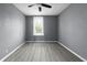 This bedroom features neutral walls, a ceiling fan, and a window for natural light at 1130 W Congress Ave, Indianapolis, IN 46208