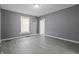 Bright, freshly painted bedroom with hardwood-style flooring and a window letting in natural light at 1130 W Congress Ave, Indianapolis, IN 46208