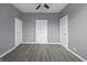 A bedroom with three doors and neutral walls provides ample access and a minimalist aesthetic at 1130 W Congress Ave, Indianapolis, IN 46208