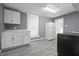 Well-lit kitchen featuring white cabinets, laminate countertops, modern appliances, and neutral walls at 1130 W Congress Ave, Indianapolis, IN 46208