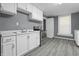 Cozy kitchen featuring white cabinets, laminate countertops, modern appliances, and bright natural light at 1130 W Congress Ave, Indianapolis, IN 46208
