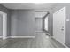 Well-lit living room offering modern flooring, neutral wall color, and an open doorway at 1130 W Congress Ave, Indianapolis, IN 46208