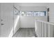 Bright enclosed porch with natural light, railing and neutral walls at 1130 W Congress Ave, Indianapolis, IN 46208