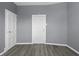 A spacious room with neutral walls and multiple doors showcases simple architectural design at 1130 W Congress Ave, Indianapolis, IN 46208