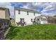 Expansive backyard featuring a patio with seating, a grill, and a lush green lawn at 11419 Pegasus Dr, Noblesville, IN 46060