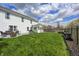 Large backyard featuring a well-kept lawn, patio with furniture, and mature trees at 11419 Pegasus Dr, Noblesville, IN 46060