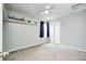 Minimalist bedroom featuring a neutral color scheme, ceiling fan, and a simple wall shelf at 11419 Pegasus Dr, Noblesville, IN 46060