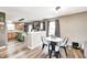 Cozy dining area featuring a modern table set, complemented by wood-look flooring and plenty of natural light at 11419 Pegasus Dr, Noblesville, IN 46060