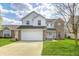 Charming two-story home featuring a two-car garage, a mix of vinyl siding and brick, and a well-maintained lawn at 11419 Pegasus Dr, Noblesville, IN 46060