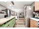 View of kitchen with stainless steel refrigerator and island leading into the open living room at 11419 Pegasus Dr, Noblesville, IN 46060