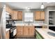 Well-appointed kitchen featuring wood cabinets, stainless steel appliances, and bright countertops at 11419 Pegasus Dr, Noblesville, IN 46060