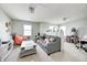 Bright living room featuring a comfortable gray sofa, complementary orange chair, and a stylish coffee table at 11419 Pegasus Dr, Noblesville, IN 46060