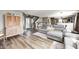 Spacious living room featuring attractive wood look floors, a comfortable sofa, and seamless transition to the entryway at 11419 Pegasus Dr, Noblesville, IN 46060