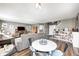 Open concept living space featuring a dining area, living room with a cozy sofa, and stylish design at 11419 Pegasus Dr, Noblesville, IN 46060