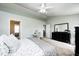 Bright bedroom with vanity and dark dresser, providing ample space at 11419 Pegasus Dr, Noblesville, IN 46060