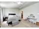 Well-lit bedroom with neutral decor, featuring a comfortable bed and vanity area at 11419 Pegasus Dr, Noblesville, IN 46060
